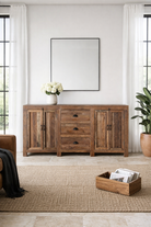 Lifestyle imagination of a reclaimed wood sideboard Avika in a rustic minimalistic design with three drawers and two double-door cabinets. A sustainable furniture piece with warm wood tones and black iron handles, perfect for eco-conscious interiors.