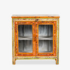 White background image of a hand-painted teak wood display cabinet with glass doors and vibrant Indian motifs – sustainable furniture with vintage charm and artisanal detail.