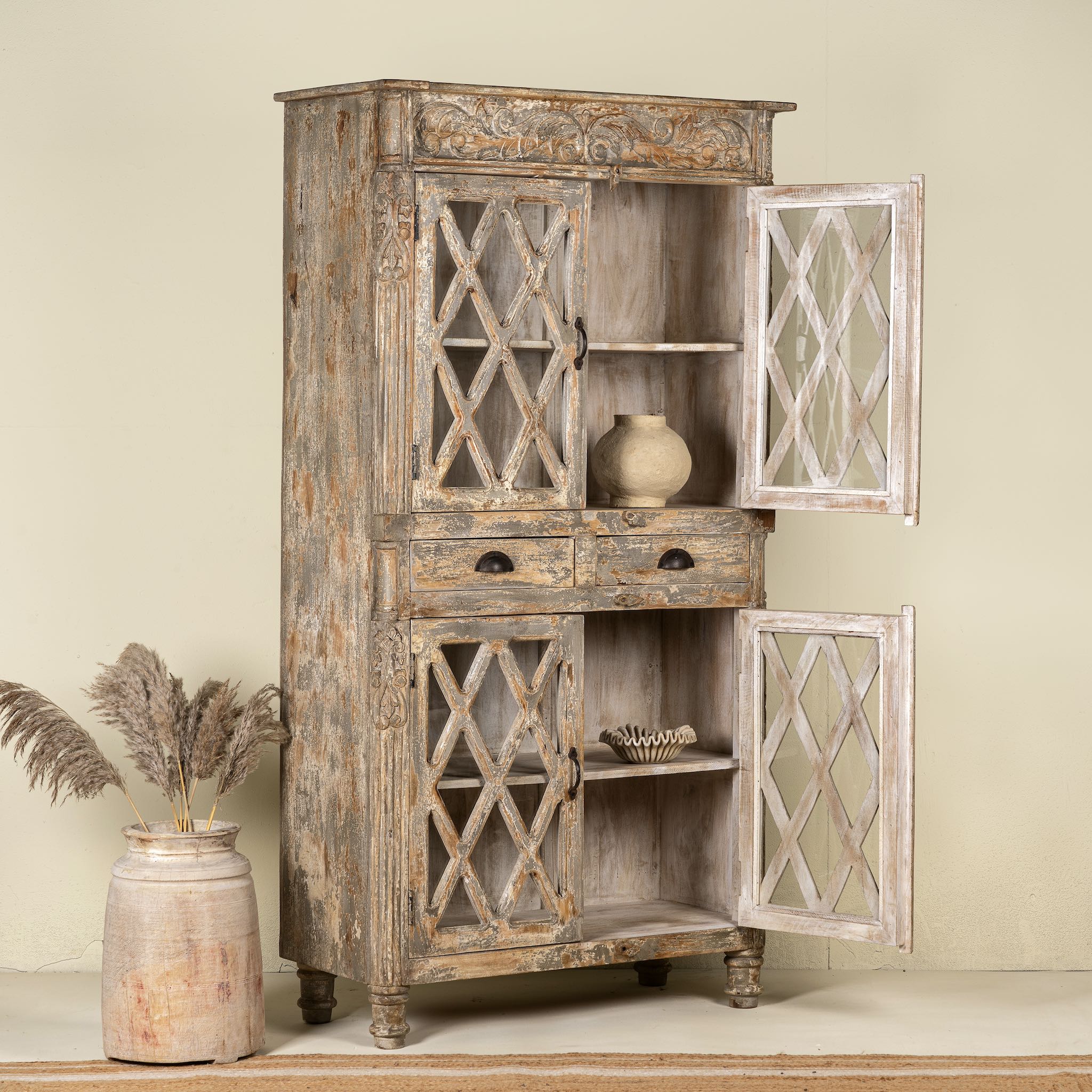 Handcrafted showcase cabinet made from reclaimed wood, featuring diamond-pattern glass pane doors, a crackled paint finish in earthy tones, two drawers, and vintage-inspired detailing.