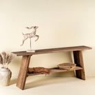 Front view image of a console table crafted from reclaimed teak wood, featuring a minimalist rustic design with angled legs and a lower shelf, showcasing the natural grain, texture, and character of the weathered wood.
