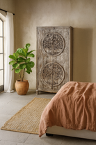 Lifestyle imagination of a vintage style wardrobe with Tree of Life design, hand-carved mango wood furniture with four storage compartments, 90 × 40 × 180 cm.