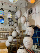 Decorative hanging lamps with intricate designs in a store setting.