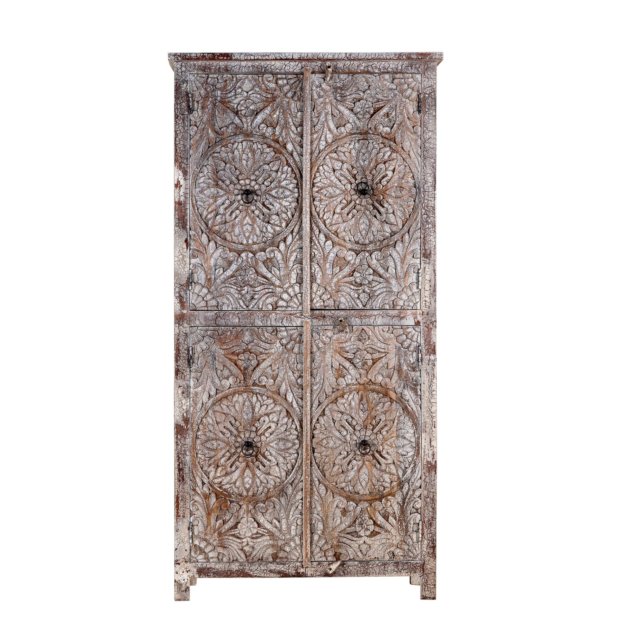 White background picture of a hand-carved acacia wood wardrobe with floral detailing and distressed finish – vintage living room furniture with artisan craftsmanship.