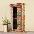 Side angle with open door image of a antique hand painted wardrobe made from reclaimed teak wood with Indian motifs; unique furniture and teak wood furniture, 113 × 50 × 190 cm.