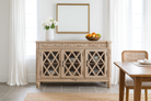 Lifestyle imagination of a rustic sideboard made of Mango wood with hand-carved details and glass panelled doors featuring a diamond lattice design.