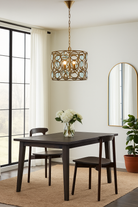 Lifestyle image of a round unique pendant light with shiny brass-plated iron frame and magnifying glass inserts – vintage lighting with elegant three-light design for kitchens, dining areas, or living rooms.