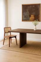 Lifestyle imagination of a rustic reclaimed wood log dining table with block legs, sustainable furniture design, 240×100×75 cm.