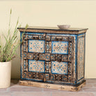 Side angle image of a cupboard made from an antique Indian old door, hand painted cabinet with blue floral details; boho style teak wood furniture, 115 × 50 × 104 cm.