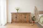 Lifestyle imagination of a hand painted wooden dresser with floral and geometric motifs, reclaimed wood living room furniture in vintage boho style, 170 × 45 × 95 cm.