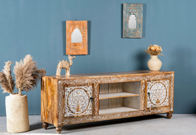 Side angle image of a whitewashed carved console table made of mango wood with floral motifs, four compartments; artisanal living room furniture, 180 × 40 × 65 cm.