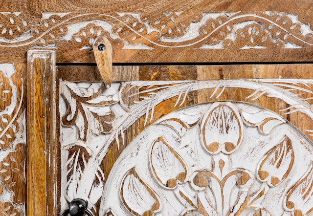 Close up image of a whitewashed carved console table made of mango wood with floral motifs, four compartments; artisanal living room furniture, 180 × 40 × 65 cm.