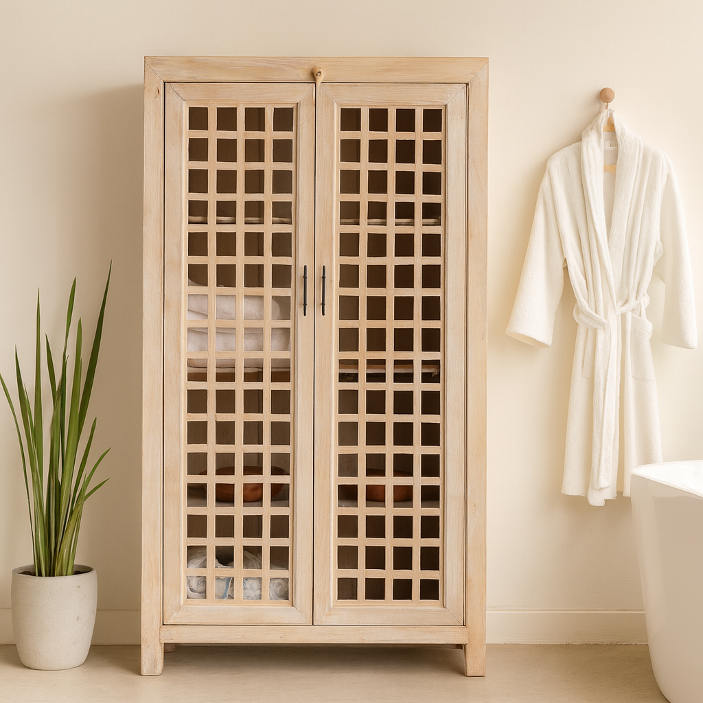 Life style image of a sandblasted mango wood showcase with two glass-panelled grid doors and four interior compartments, finished in a light sun-washed tone, ideal as living room furniture.