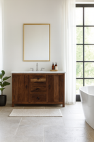 Lifestyle image of a wabi sabi furniture driftwood sideboard with white marble top, minimalist Japandi cabinet with drawers and sliding surface, 125 × 35 × 75 cm.