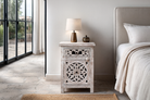 Lifestyle image with a Whitewashed nightstand made of mango wood with Mediterranean-style carved detailing and one drawer – Gagan bedside table by Om Home & Garden