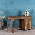 Side view of a desk made of reclaimed wood in Wabi Sabi style decorated in a living room scene.