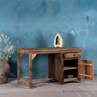 Open door view of a desk made of reclaimed wood in Wabi Sabi style decorated in a living room scene.