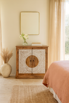 Lifestyle imagination of a carved wood furniture cabinet made from mango wood with floral whitewashed doors, 90 × 40 × 90 cm.