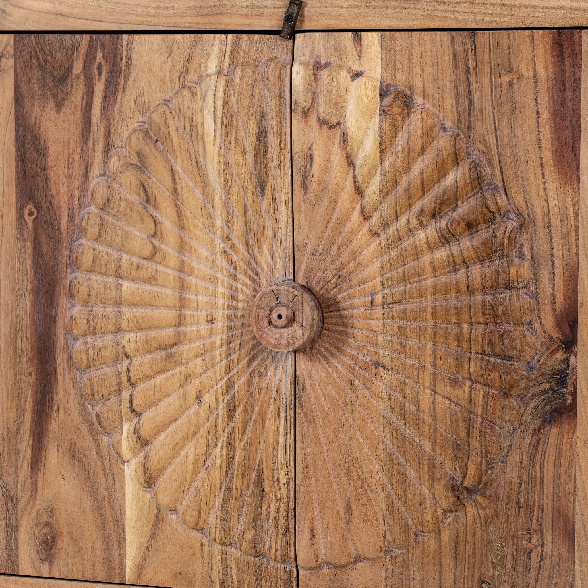 Close up picture of a carved acacia wood sideboard with four doors, two drawers, brass handles, and tapered legs; artisanal acacia wood furniture, 180 × 40 × 90 cm.