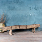 Antique console table repurposed from reclaimed teak wood feeding trough with carved details and iron fittings; unique furniture ideal for rustic interiors, compatible with teak wood benches, 234 × 31 × 61 cm.
