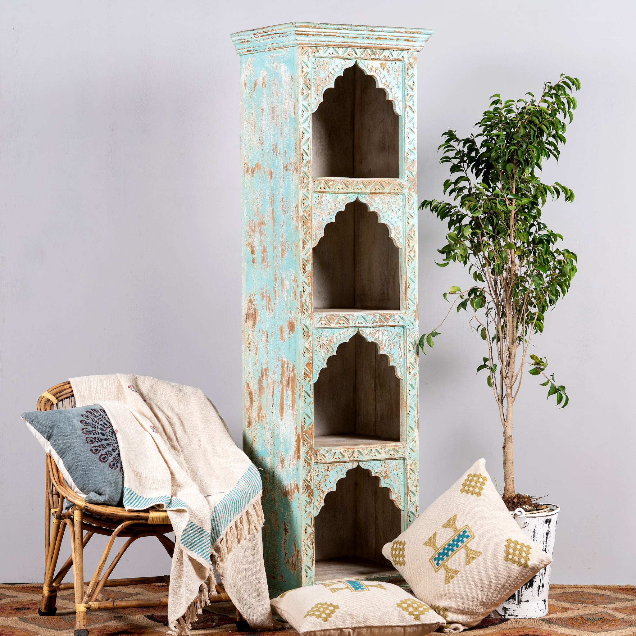 Side angle image of a hand-carved mango wood bookshelf with oriental detailing and natural wood finish – carved wooden furniture and vertical shelving for refined, rustic interiors.