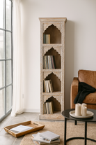 Lifestyle image of a hand-carved mango wood bookshelf with oriental detailing and natural wood finish – carved wooden furniture and vertical shelving for refined, rustic interiors.