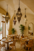 Lifestyle scene of a handcrafted punched metal pendant lamp Ichaa in mixed colours – 80 cm high oriental lighting with intricate patterns, ideal as decorative metal pendant light.