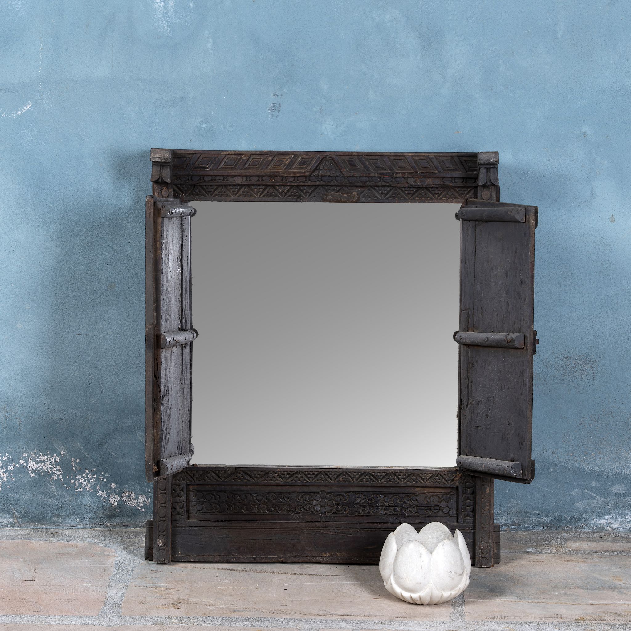 Reclaimed teak wood mirror with functional window shutters, showcasing vintage craftsmanship and rustic carved accents.