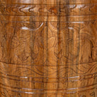Close up picture of a round barrel type mango wood side table with hand carved floral design.