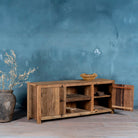 Side view image with open door of a rustic sideboard in Driftwood/Wabi Sabi style made from recycled old wood, featuring a natural, weathered finish with two cabinet doors and open central shelving.


