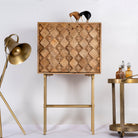 Tall mango wood cabinet in sandblasted finish with geometric sunburst design and brass handles, 76 × 38 × 135 cm.