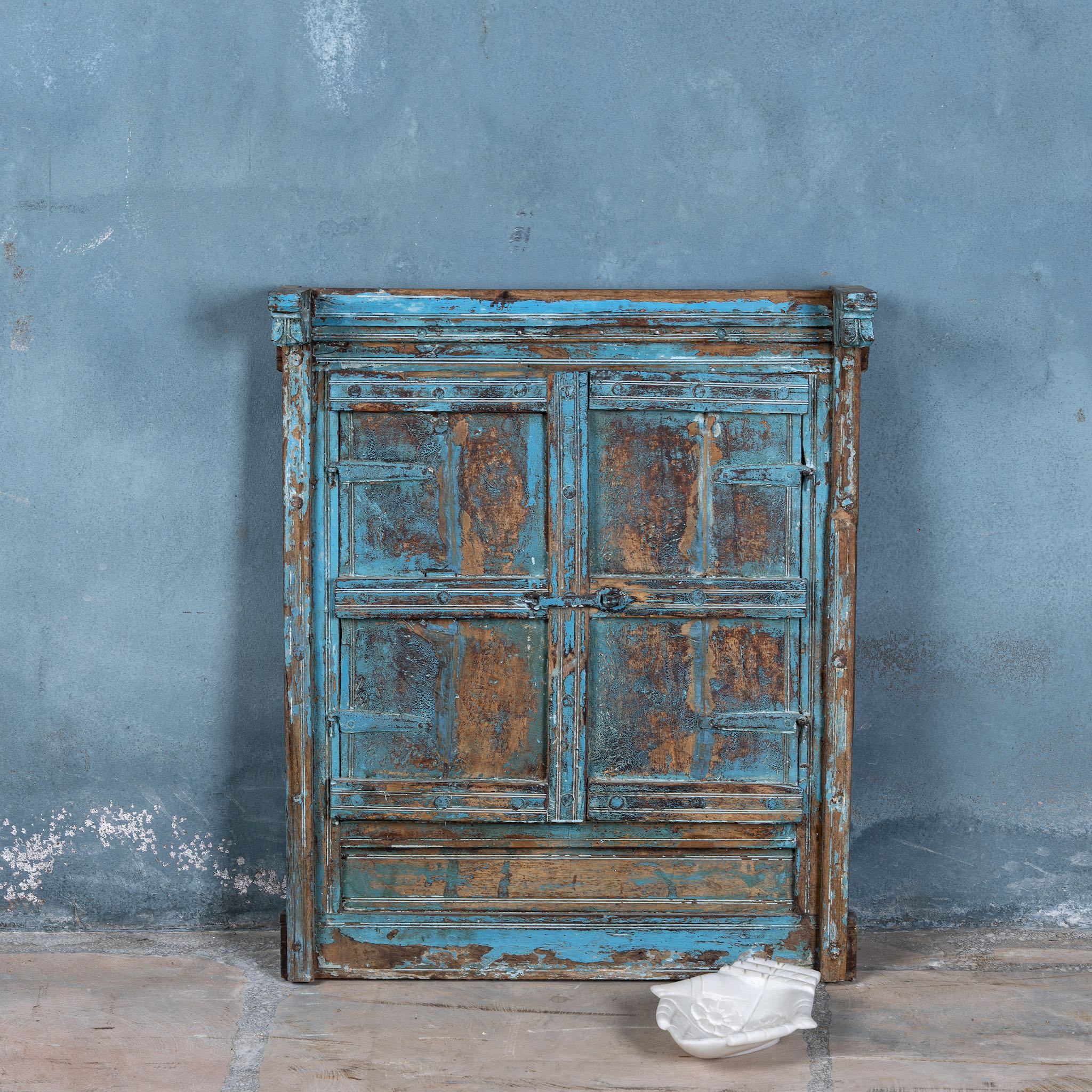 Reclaimed teak wood blue mirror with functional window shutters, showcasing vintage craftsmanship and rustic carved accents.