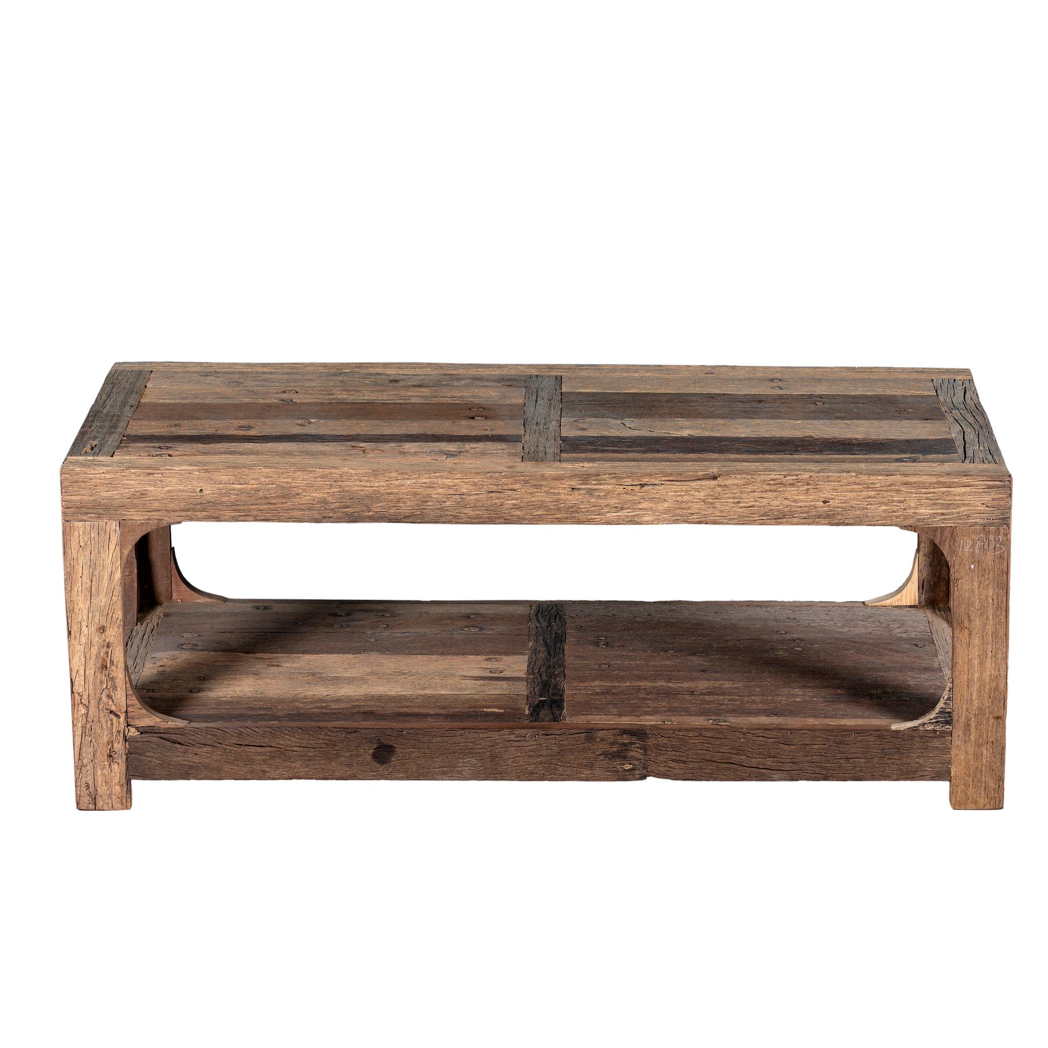 White background view of a coffee table made of reclaimed wood in Wabi Sabi style decorated in a living room scene.