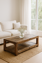 Lifestyle imagination of a driftwood coffee table made from reclaimed wood with rustic finish and open lower shelf; sustainable furniture, 120 × 60 × 40 cm.