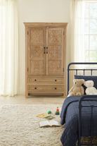 Lifestyle suggestion for a hand-carved mango wood cabinet with floral and geometric detailing – carved wooden furniture and elegant bedroom storage by Om Home & Garden.