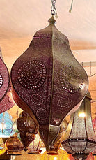 Decorative hanging lanterns with intricate designs in a warm indoor setting.