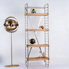 Side angle image of a compact brass-plated iron shelf with removable mango wood trays – minimalistic furniture and modular mango wood shelving for stylish, functional interiors.