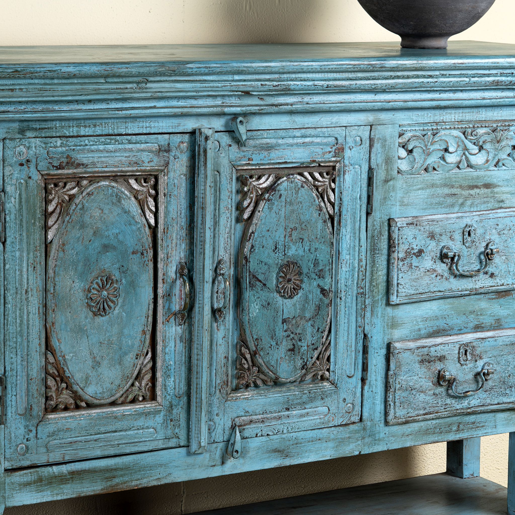 Vintage-style blue wooden cabinet with intricate carvings