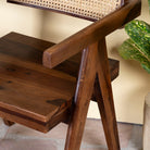 Close up image of an acacia wood chair with rattan backrest and armrests; elegant wooden armchair for dining or living rooms, 55 × 55 × 85 cm.