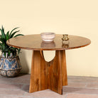 Round mango wood dining table with natural grain and sturdy base; solid wooden dining table for dining rooms, 130 cm diameter × 100 cm height.