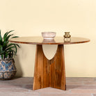 Round mango wood dining table with natural grain and sturdy base; solid wooden dining table for dining rooms, 130 cm diameter × 100 cm height.