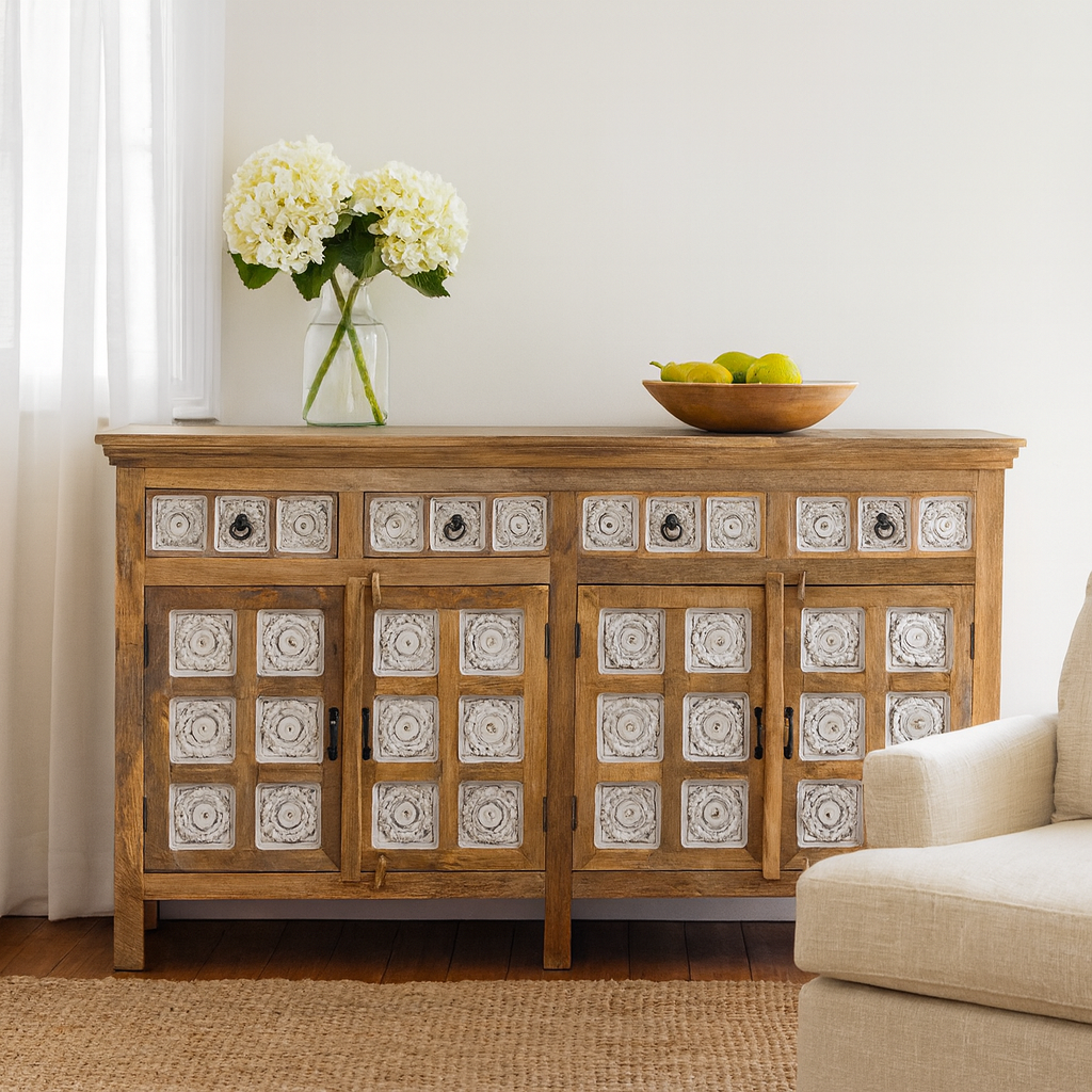 Lifestyle imagination of a  hand-carved mango wood sideboard with whitewashed floral details; perfect as living room furniture or mango wood furniture for vintage interiors, 180 × 100 × 40 cm.