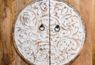 Close up image of a carved wood furniture cabinet made from mango wood with floral detailing and whitewashed finish, 90 × 90 × 40 cm.