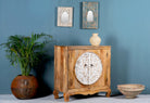 Side angle image of a carved wood furniture cabinet made from mango wood with floral detailing and whitewashed finish, 90 × 90 × 40 cm.