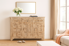 Wooden sideboard with decorative items in a living room setting