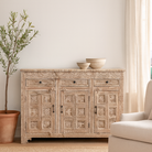 Lifestyle Imagination of a hand-carved mango wood cabinet with three drawers and vintage distressed finish; ideal for mango wood furniture lovers and vintage home decor, 150 × 110 × 40 cm.