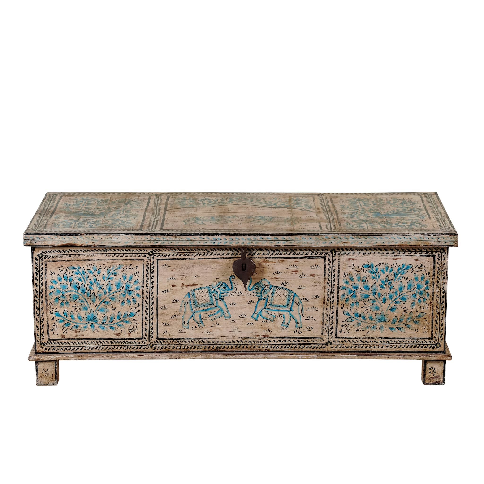 White background image of a large hand-painted chest made from old reclaimed wood, featuring intricate blue designs of elephants and floral motifs on a distressed beige background, with a central latch and a rustic vintage finish.
