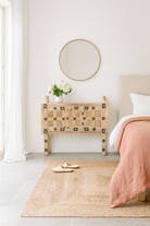 Lifestyle image of a sandblasted antique Indian teak chest with hand-carved details, original iron fittings, and a naturally aged finish, ideal for bohemian or vintage-inspired interiors.