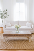 Lifestyle imagination of a Lata teak wood coffee table with antique carved door top, also ideal as an entryway table vintage statement piece.