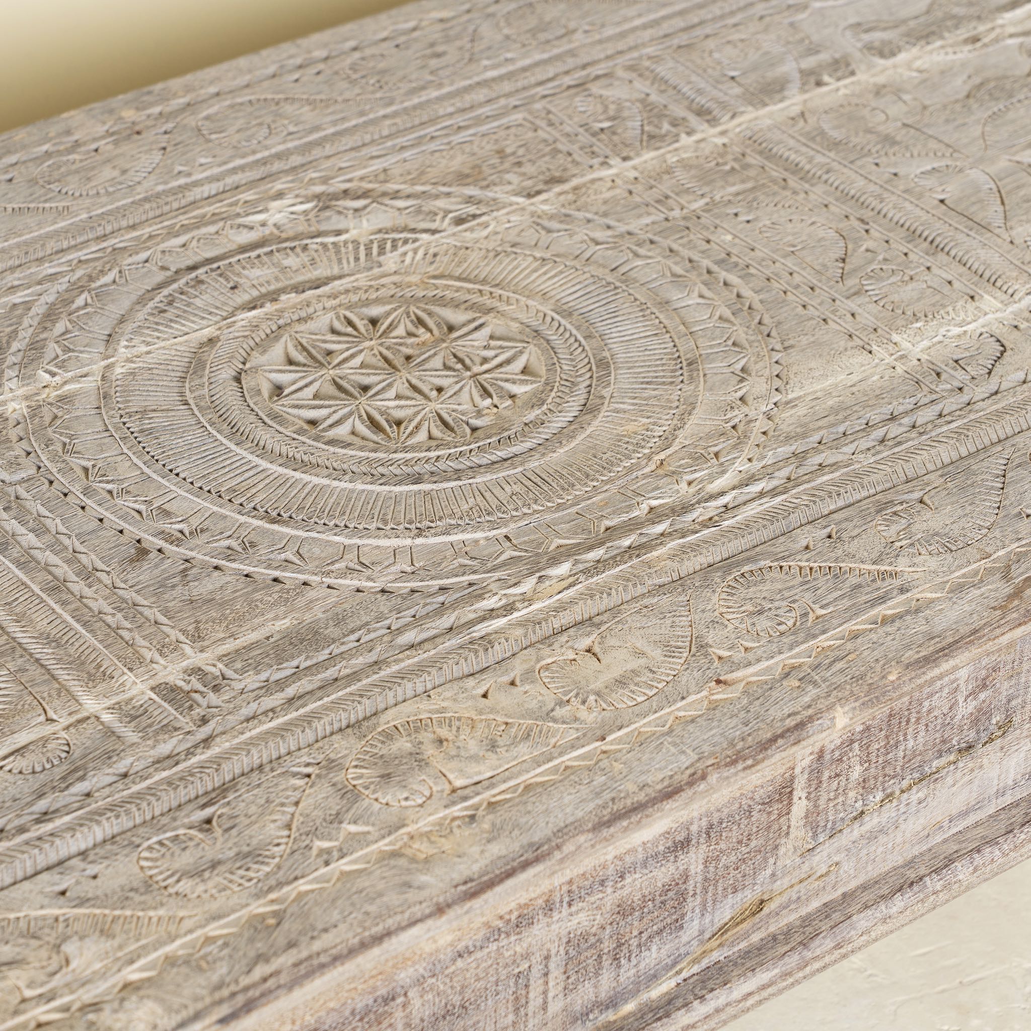 Close-up of a wooden surface with intricate carvings and patterns