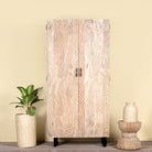 Hand-carved mango wood wardrobe with sandblasted finish and iron stand; artisanal bedroom furniture, 90 × 46 × 183 cm.